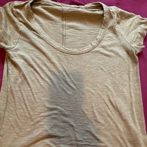 Golden coloured t shirt.